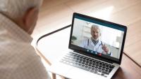 A patient has an online consultation with a doctor via a laptop