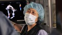 Dr. Becky Han discusses cardiac image with team during interventional procedure.