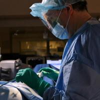 Dr. John Abbott wearing scrubs and preparing for surgery.